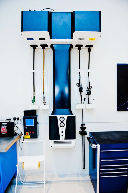 Orthopedic traction machine with blue weights and pulleys in a medical facility.