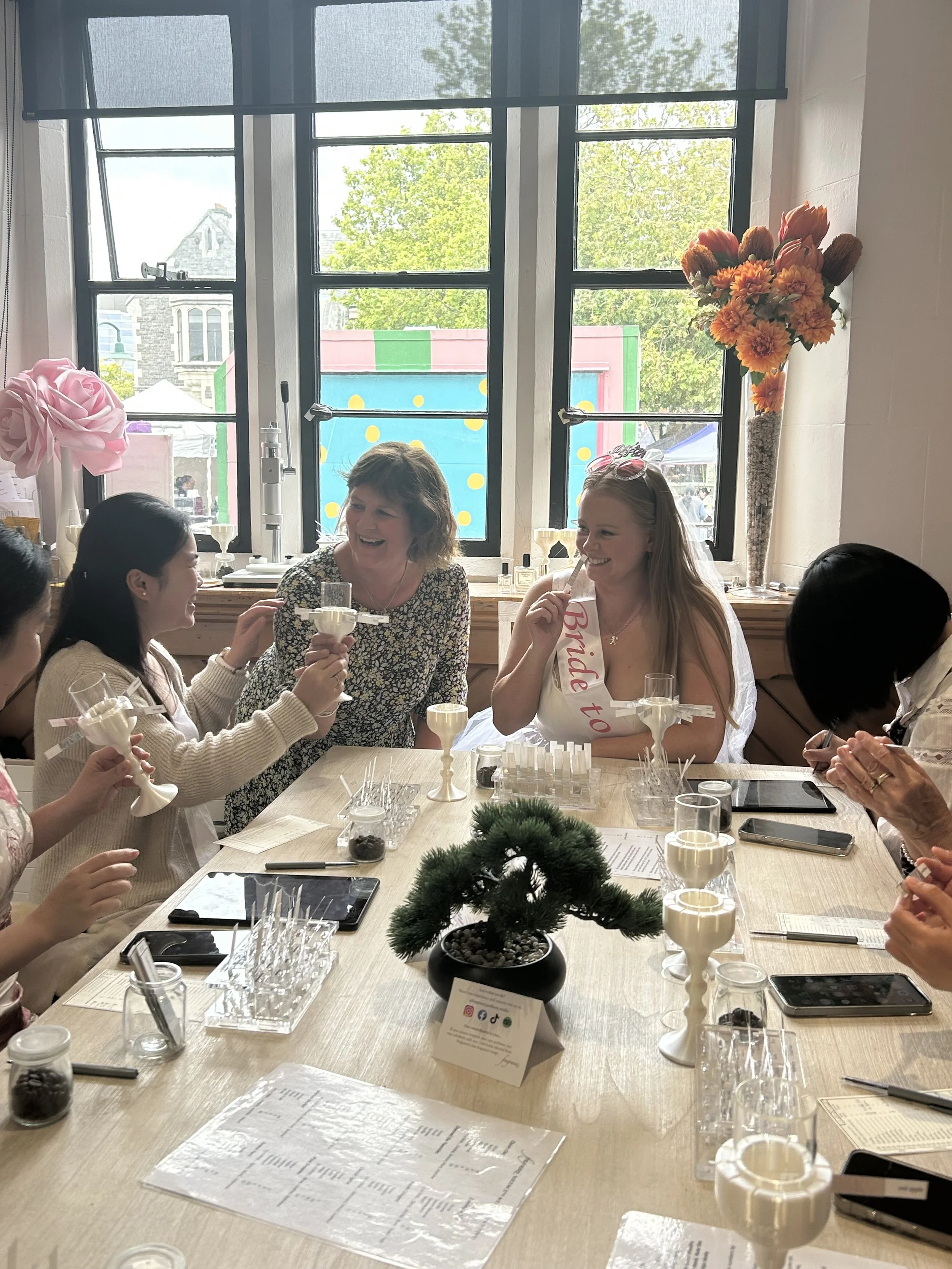 A hen's party of women designing their signature perfumes together.