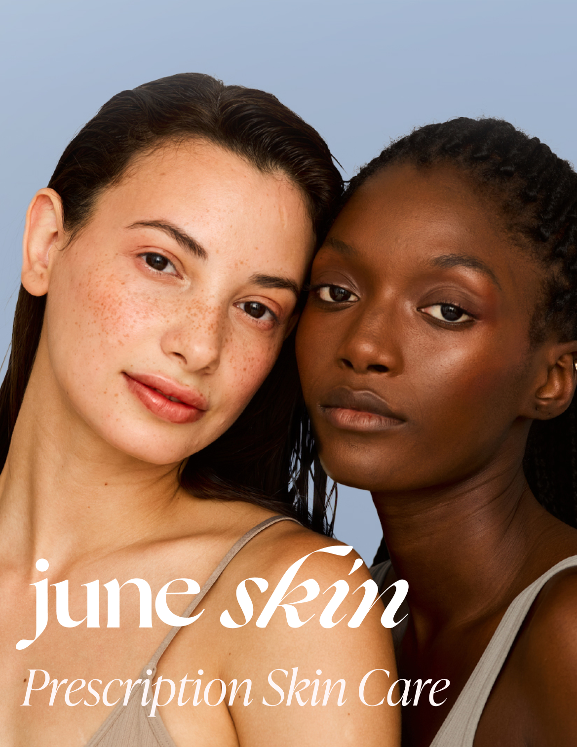Close-up of two women with different skin tones, one with freckles and the other with darker skin, smiling and looking at the camera, against a light blue background with the text "June Skin" and "Prescription Skin Care."