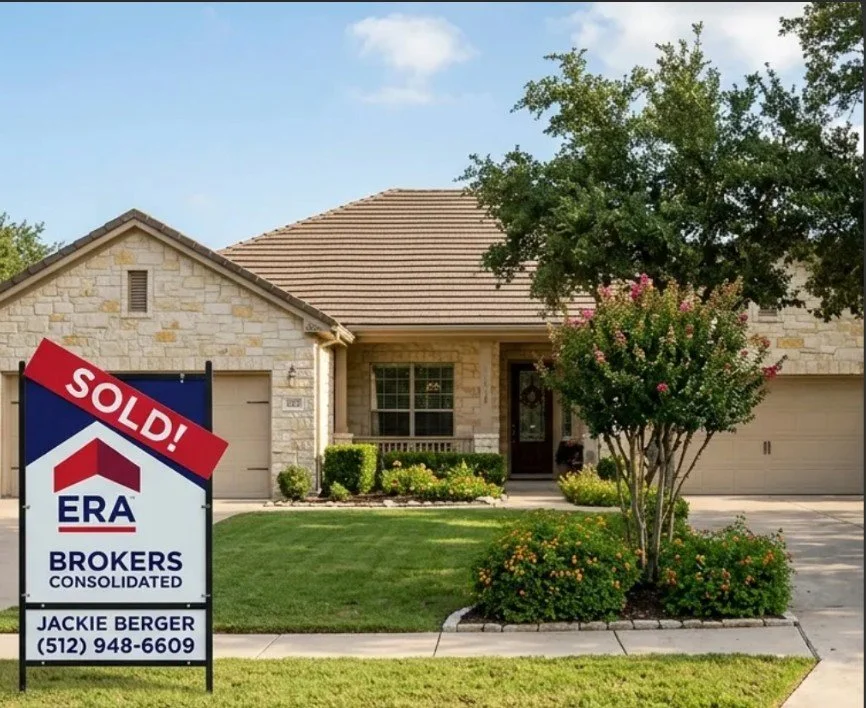 A house with a stone exterior, front yard, and a garage. A "SOLD!" sign from ERA Brokers is placed in the lawn, with contact information for Jackie Berger.