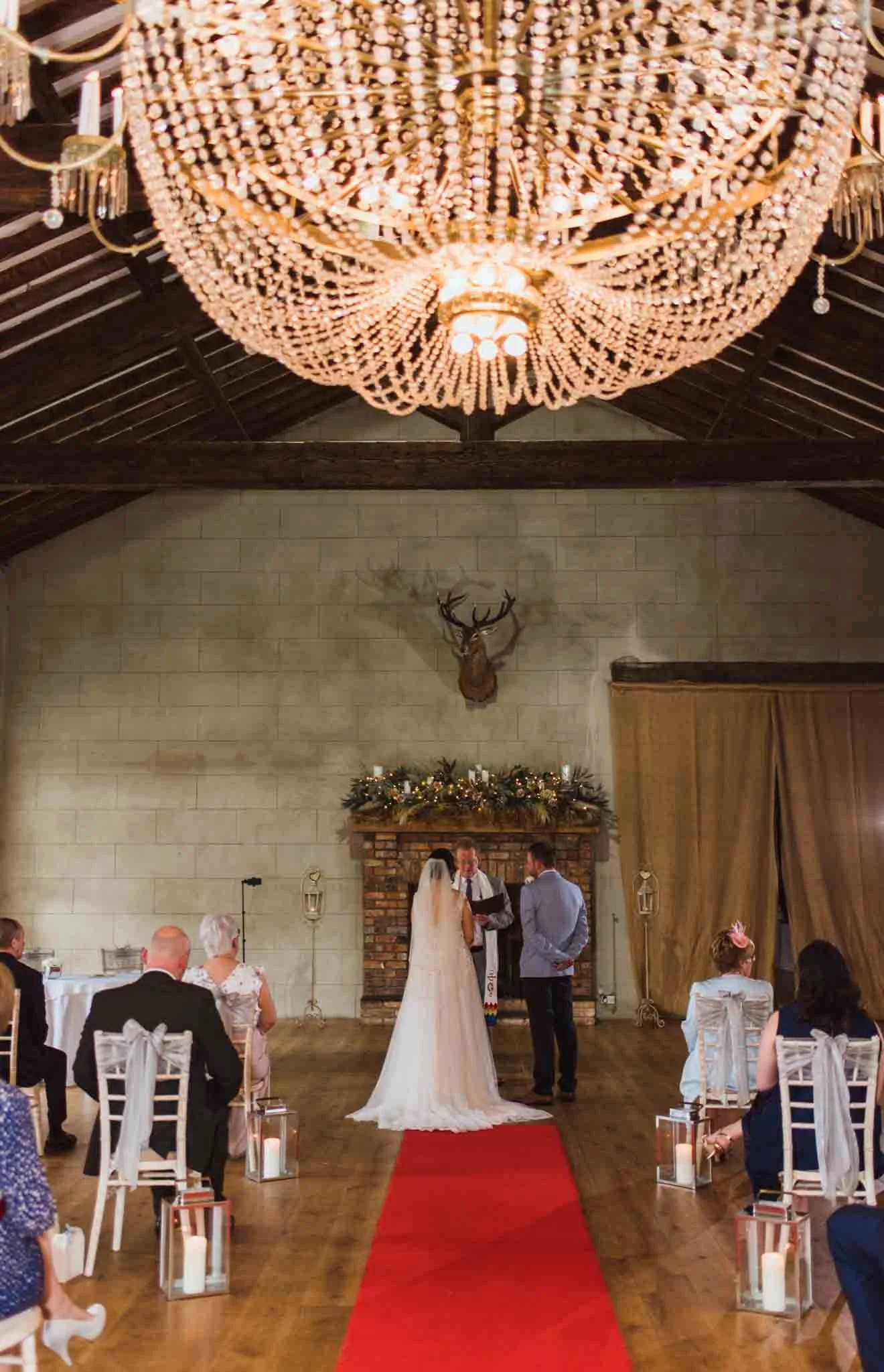 The couple standing under a chandelier booked me for an average wedding video price.