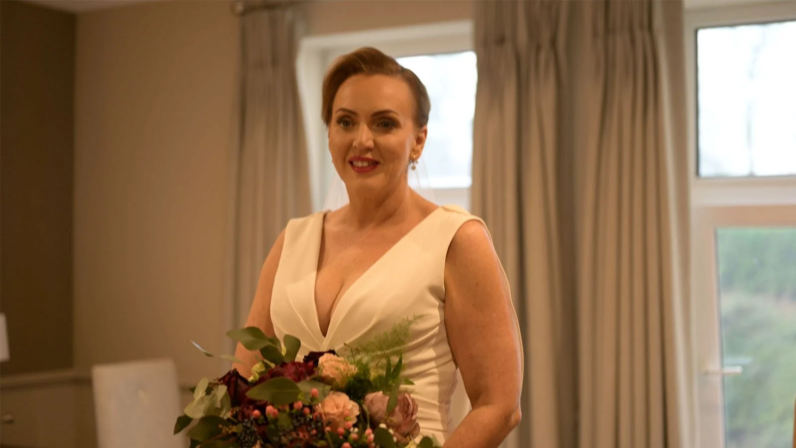  Bride holding a bouquet, looking at the camera. 