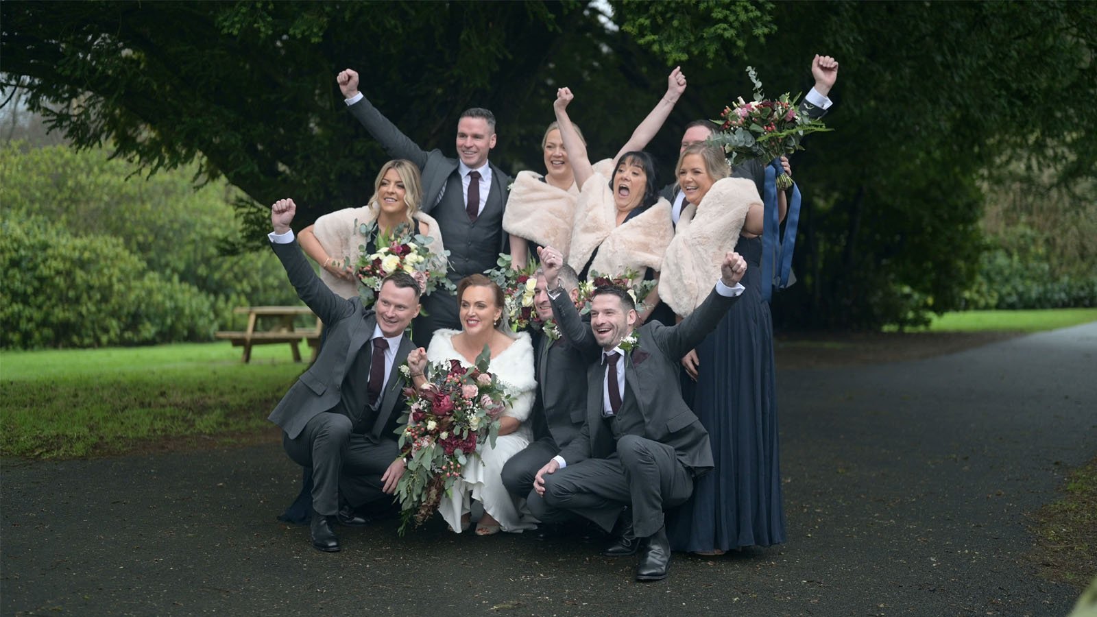  Bridal party on the path, cheering in the park. 