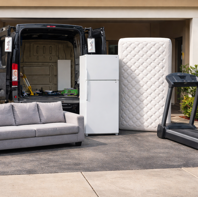 living room with oversized sofa and old treadmill