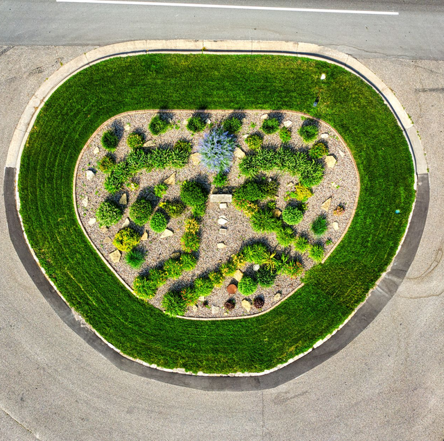 water pooling around center island of gravel driveway