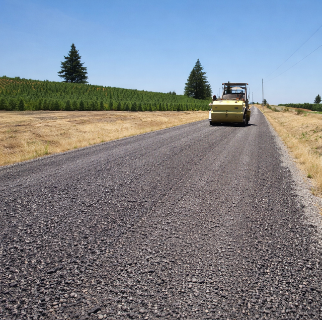 two adjacent driveways one rough millings one smooth paved asphalt