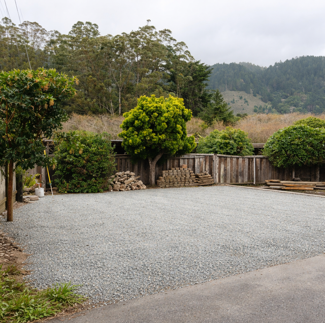 gravel turnaround pad beside asphalt driveway with parked pickup truck