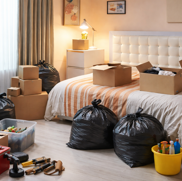 crowded garage filled with stacked moving boxes