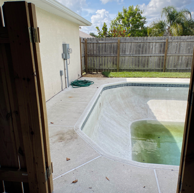 crew measuring cracked pool with tape and depth gauge