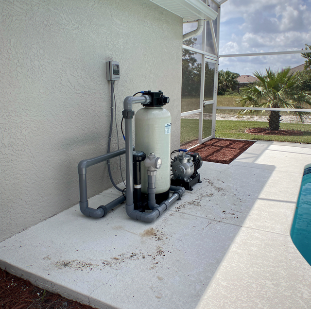 pool equipment pad with rusty pump and faded filter tank