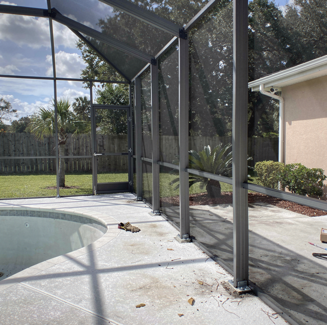 aluminum pool cage footers sitting on concrete demolition