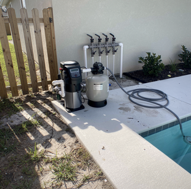 attached spa sharing pool plumbing under deck