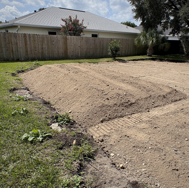 excavator pulling concrete pool shell from backyard