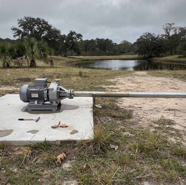 centrifugal pump beside still pond at dusk