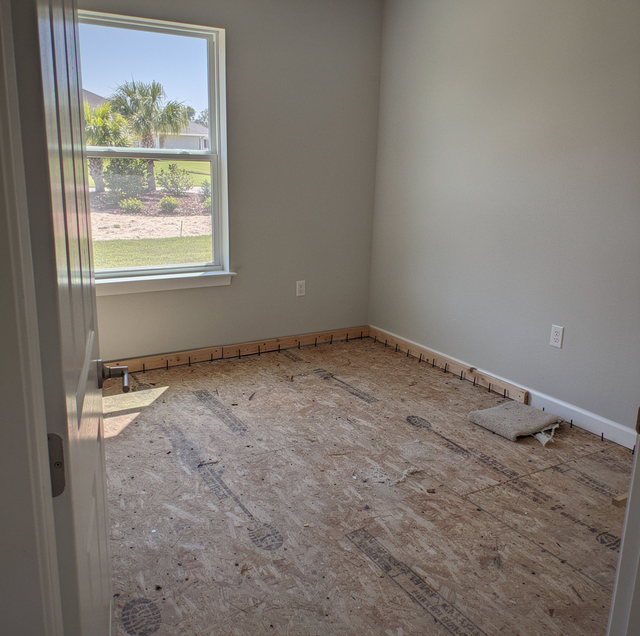 stained carpet rolled back during rental turnover