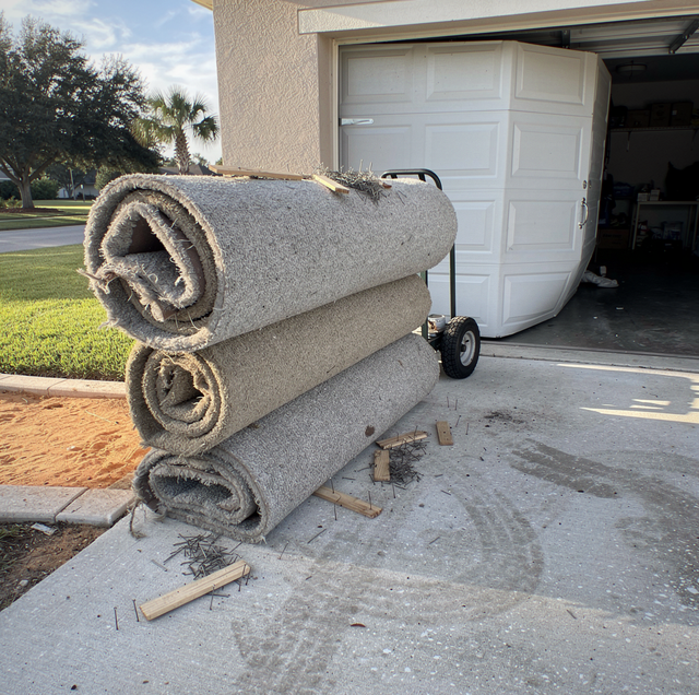 rolled carpet stack near open job site boxes