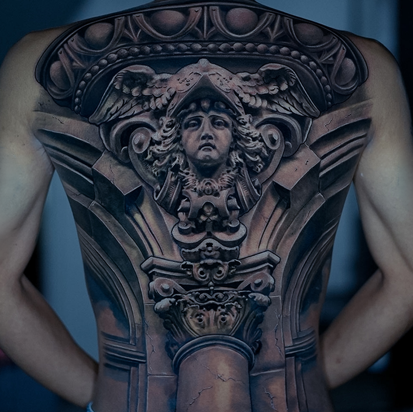 Large scale full back architectural tattoo by Glen Middleton featuring a classical marble face and ornate stonework in black and grey realism.