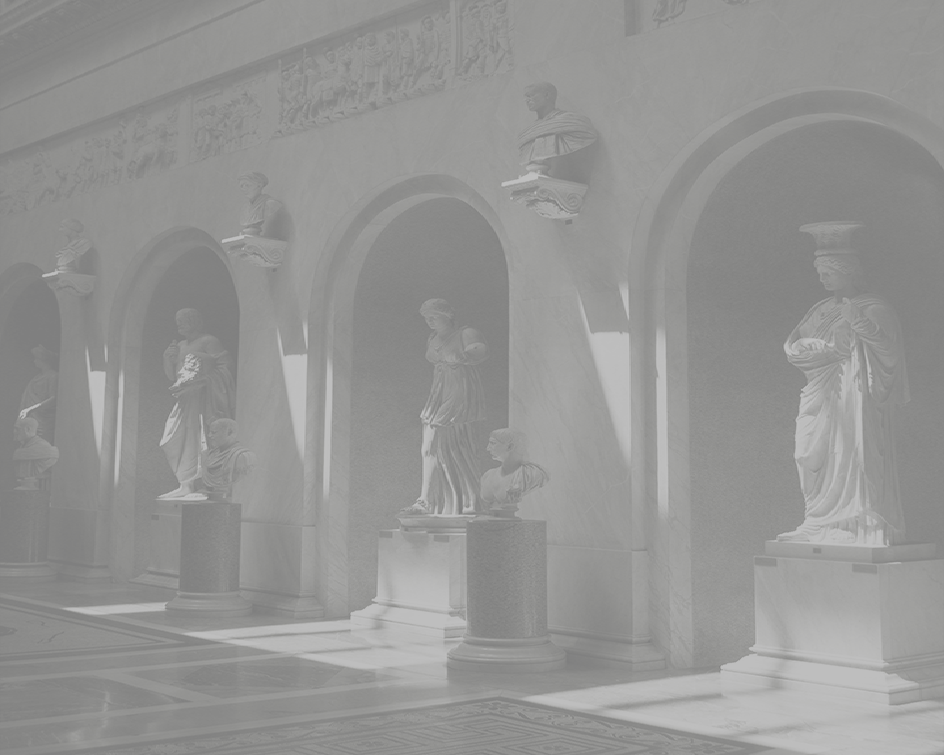 Marble statues of historical figures displayed in alcoves inside a museum hall.