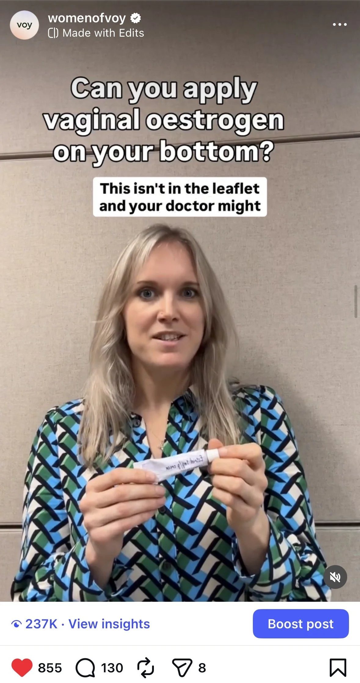 A woman in a patterned blouse is holding a small white tube of vaginal estrogen treatment in front of a beige wall. Text overlay questions whether vaginal estrogen can be applied on the bottom and notes that this information isn't in the leaflet, suggesting a medical or health-related context.