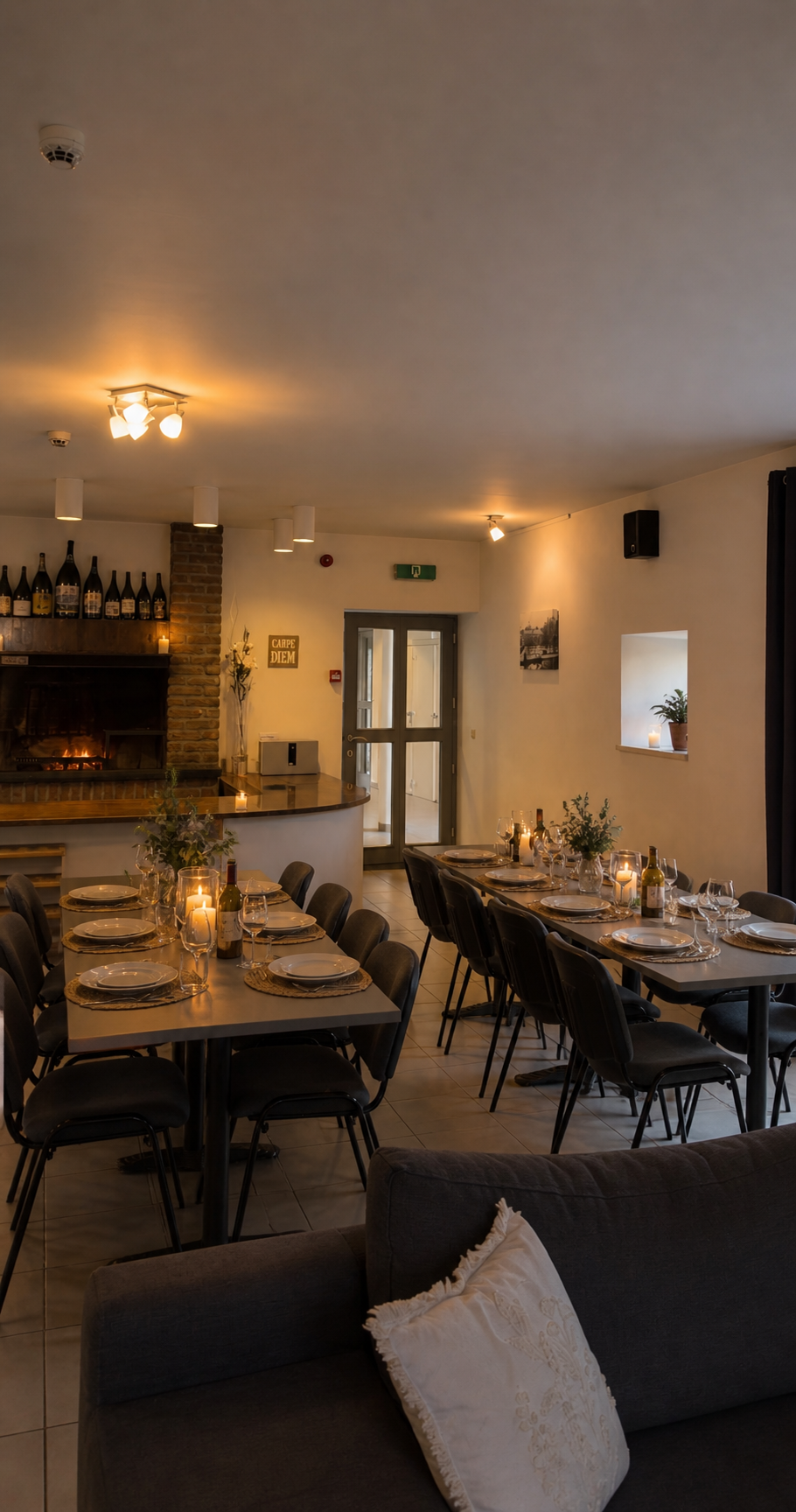 An elegant communal dining room with two long tables set for dinner under warm lighting at a wellness retreat.