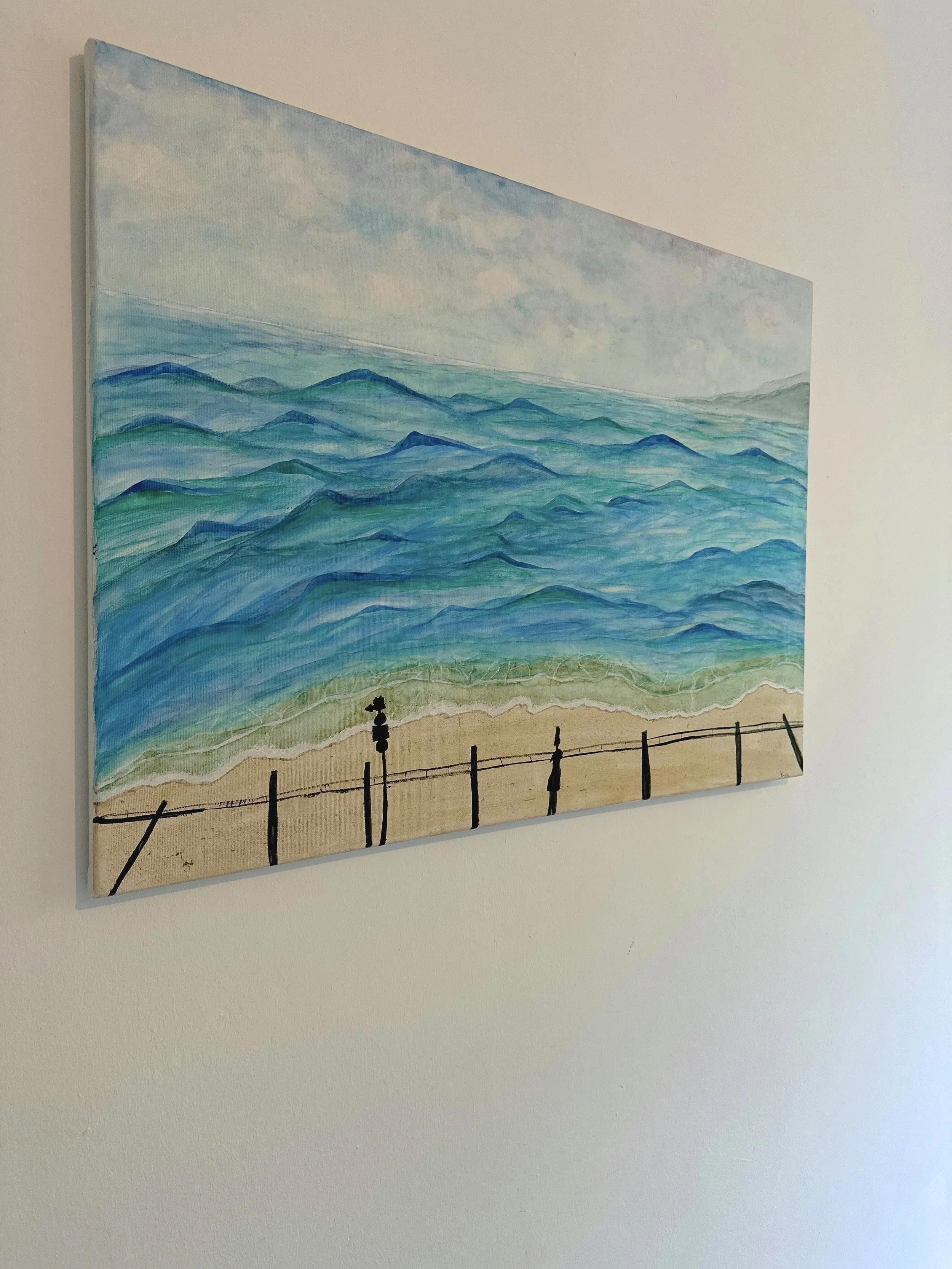 A painting of the ocean with waves, a sandy shoreline, and a railing with posts in the foreground.