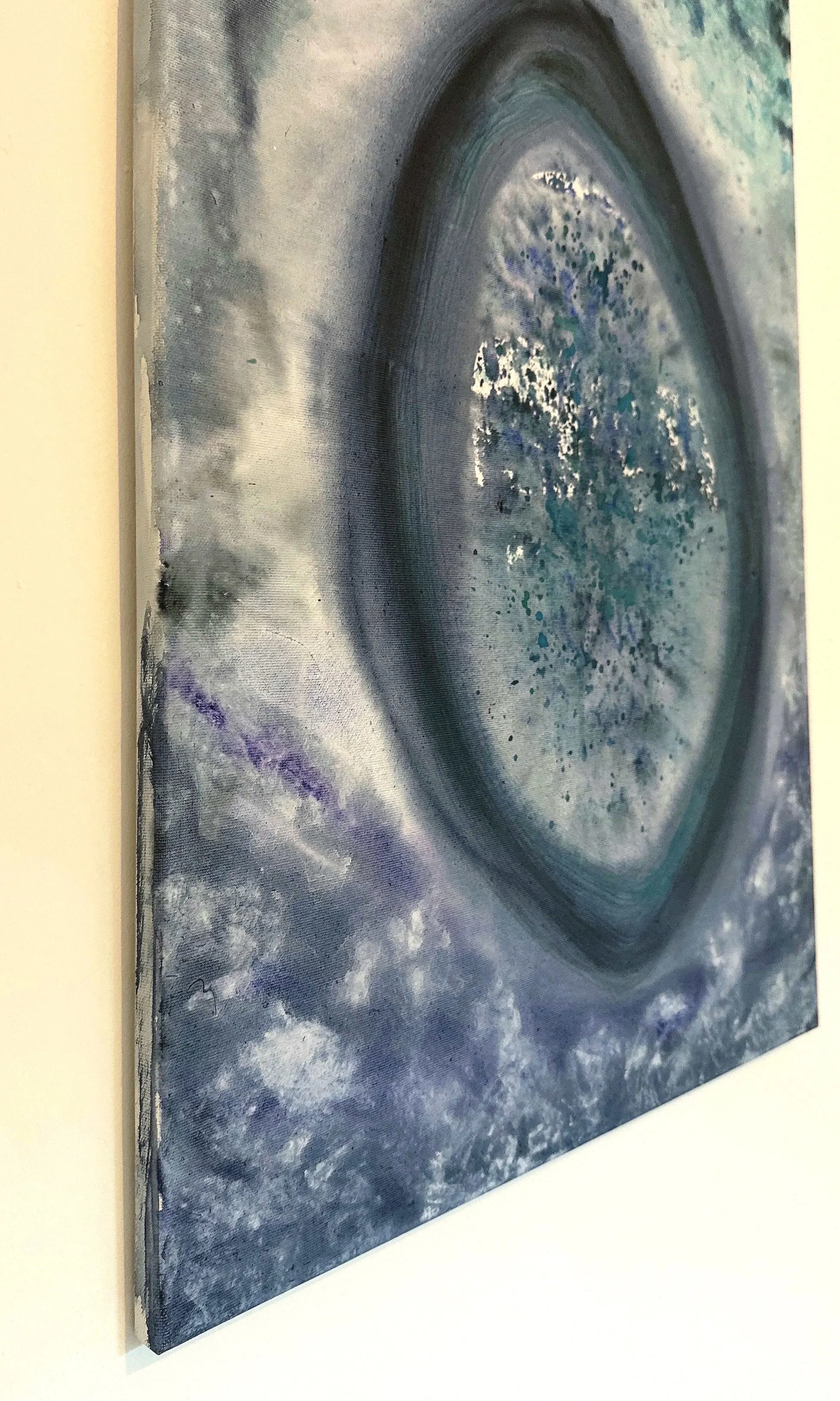 Abstract painting featuring circular patterns, swirling shades of blue, gray, black, white, and touches of purple and green