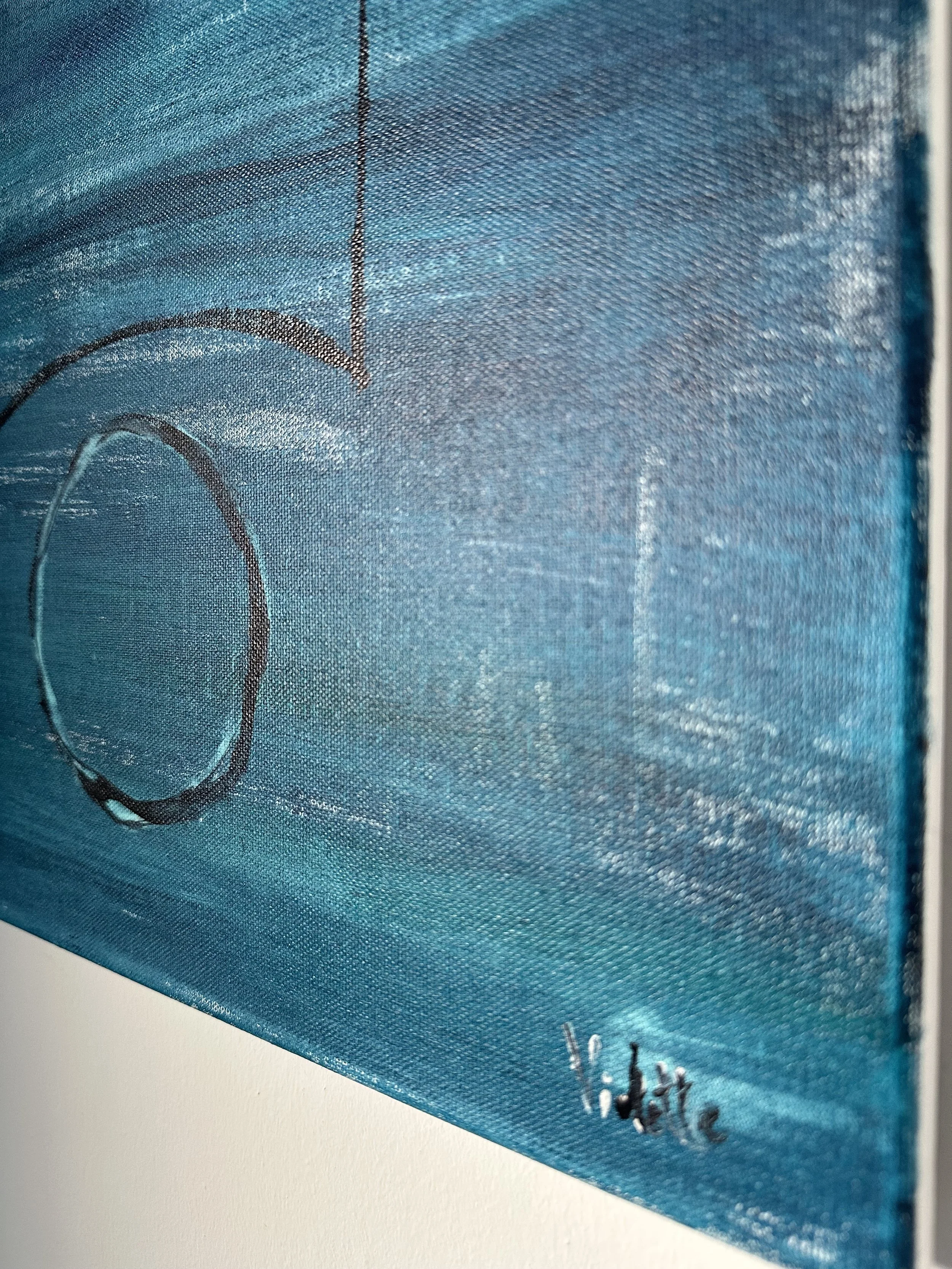 Close-up of a blue box with black text and a circle design on the side.