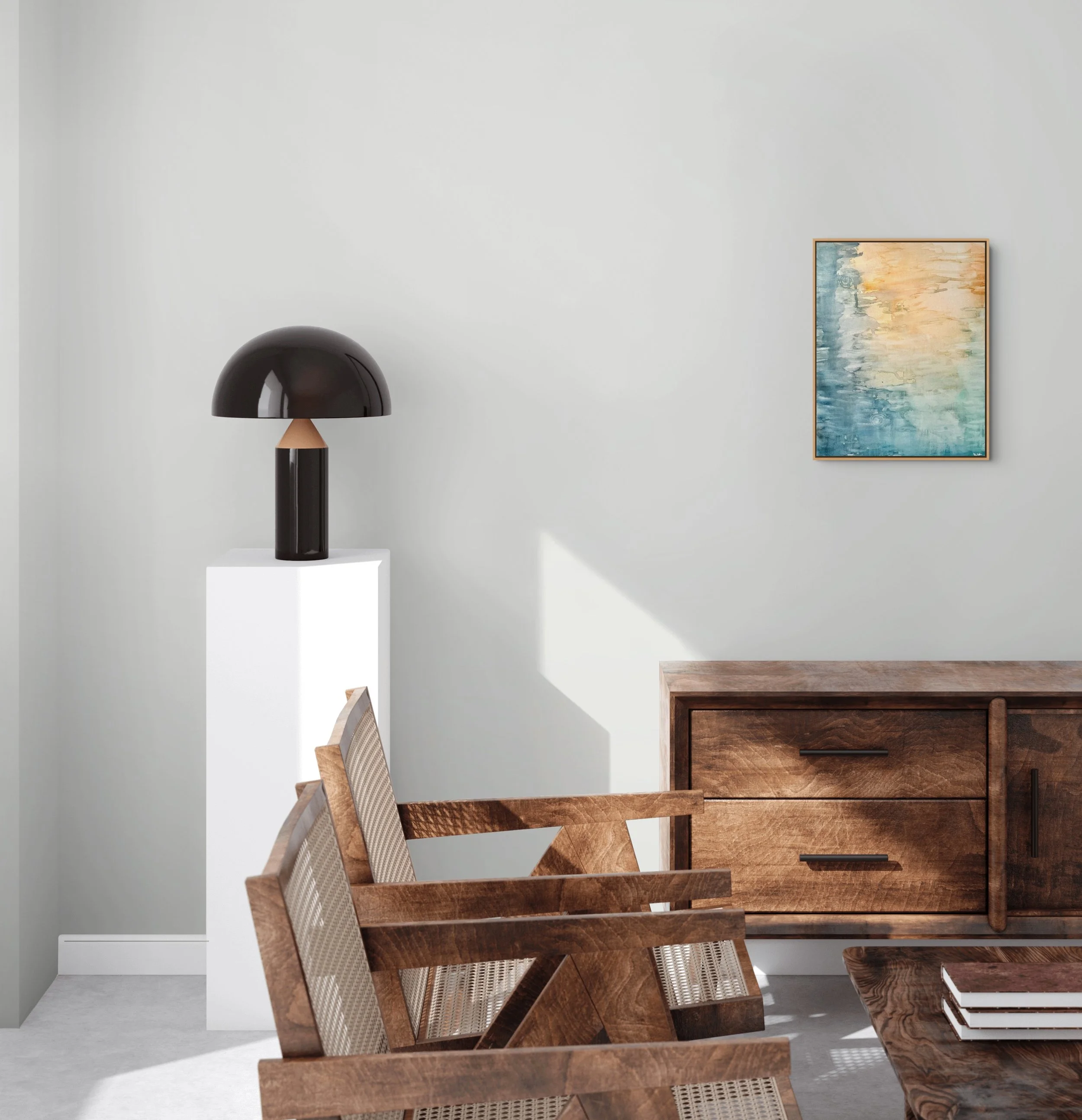 Interior of a room with a modern dark brown desk, a black dome-shaped table lamp, and a framed abstract painting with blue, yellow, and beige colors on the white wall.