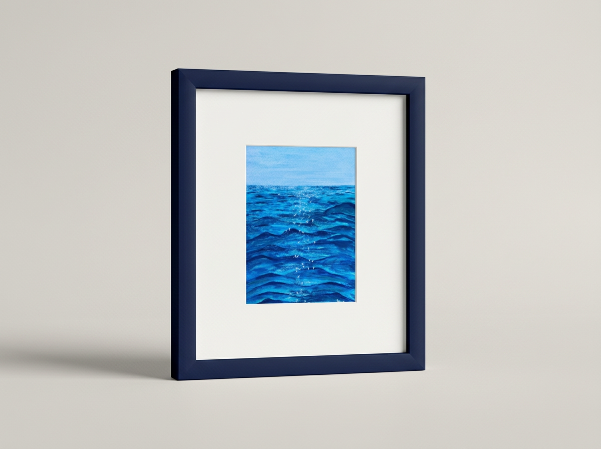 Painting of blue ocean waves in a blue frame on a white wall