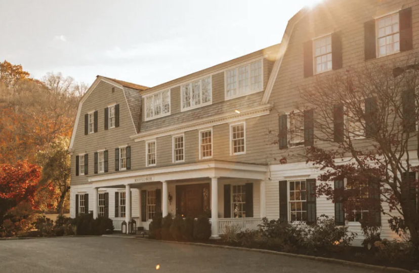 The 1894 shingle-style Mayflower Inn & Spa amid autumn woodland in Litchfield County, Connecticut.
