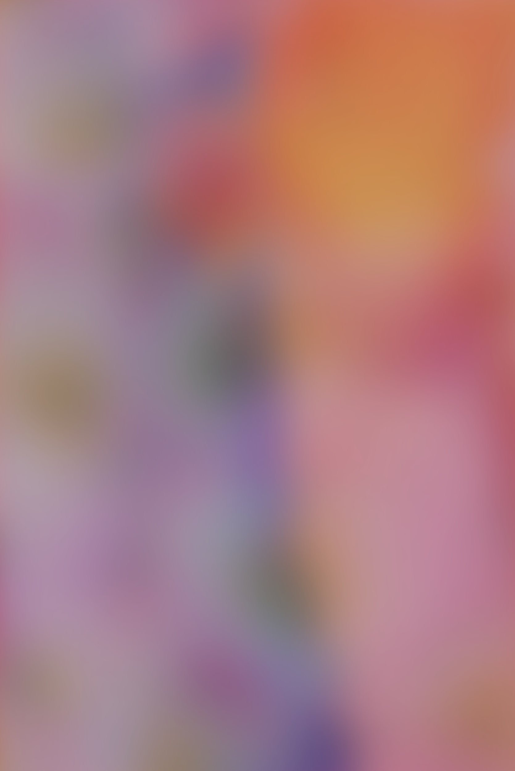 Blurred colorful background with shades of purple, pink, orange, and gray.