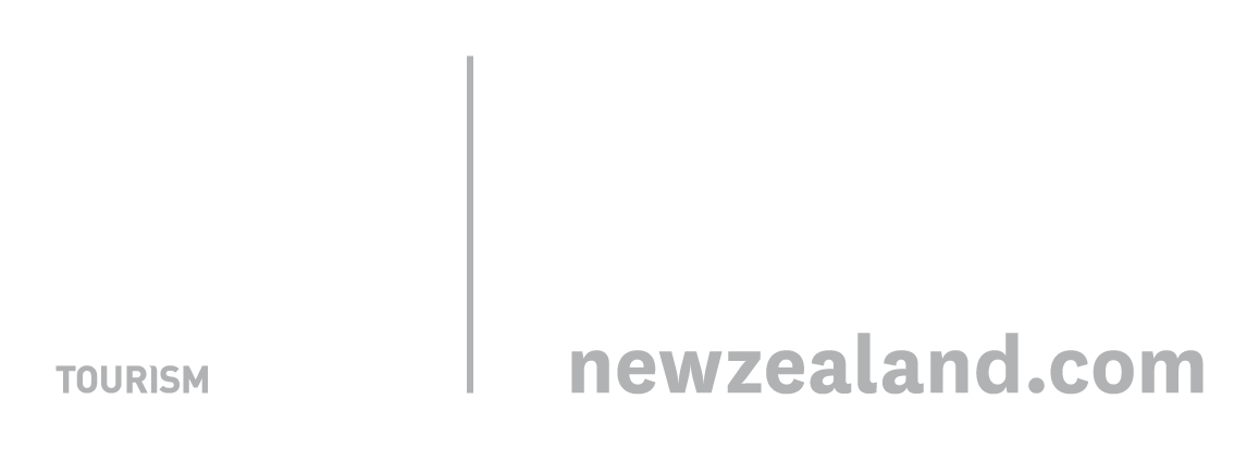 Logo of New Zealand Tourism with a stylized fern leaf, text stating "100% Pure New Zealand" and the website URL "newzealand.com".