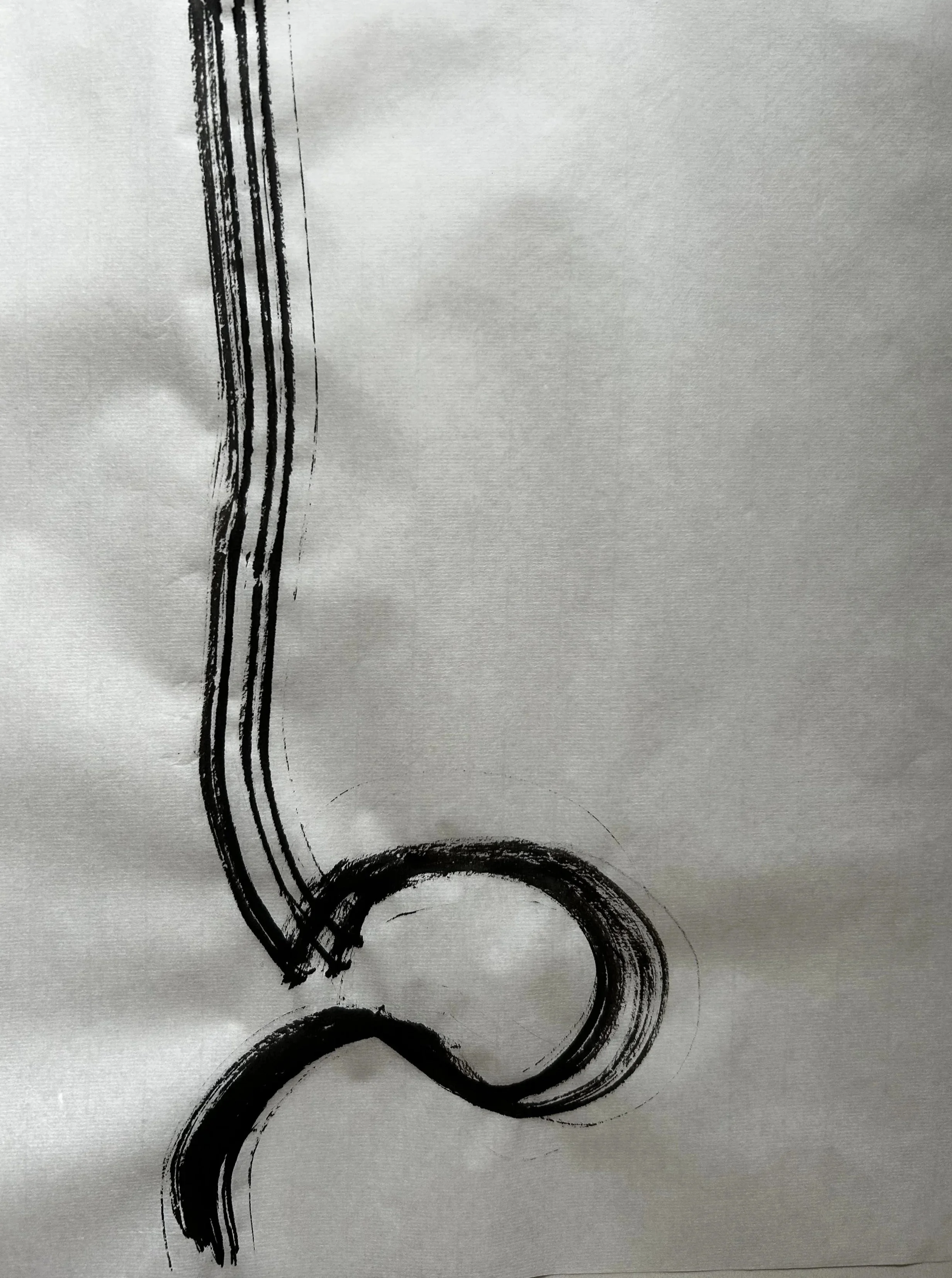 Black ink sketch of a musical note on white paper.