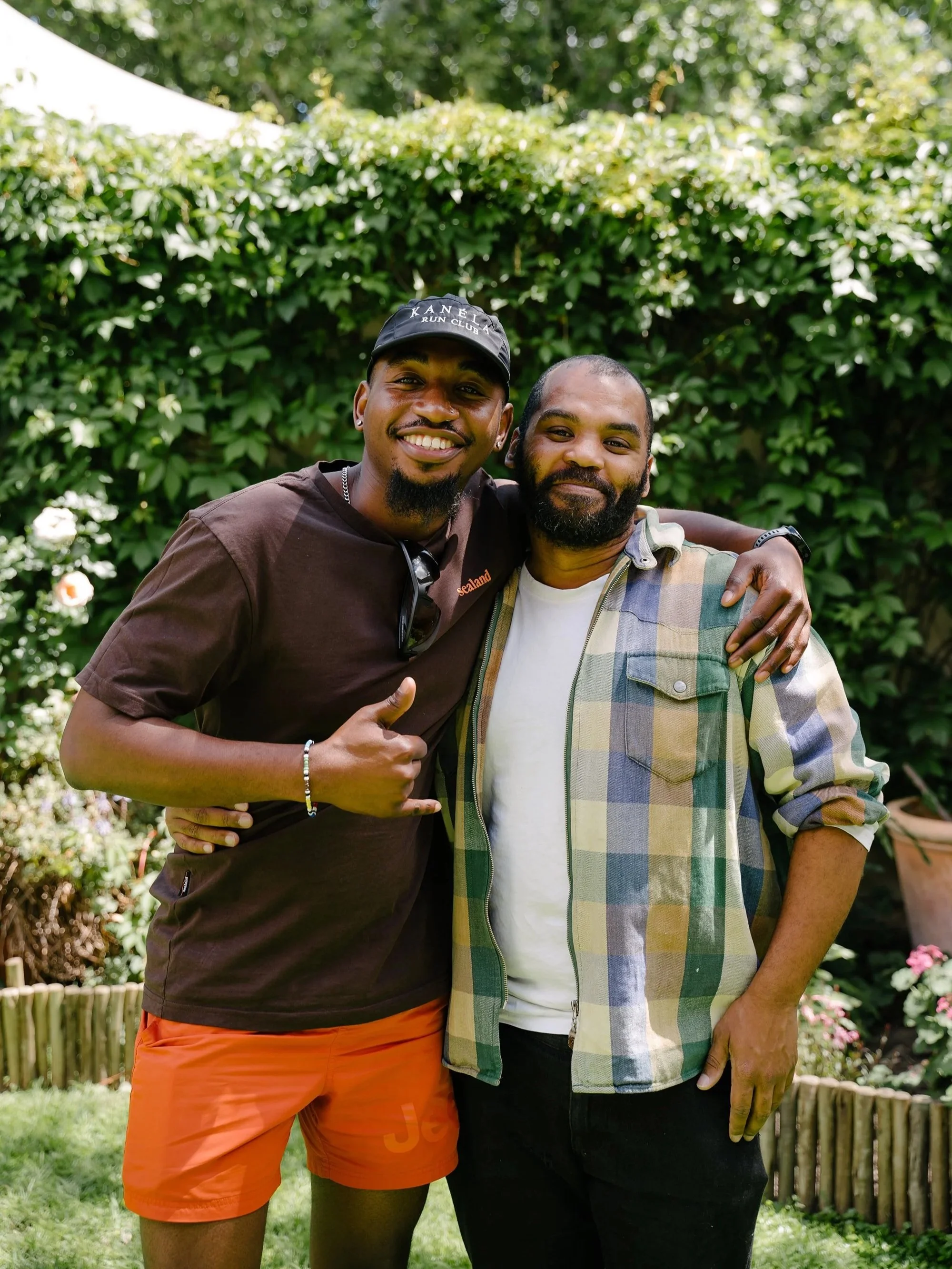 Two men smiling together in the church garden