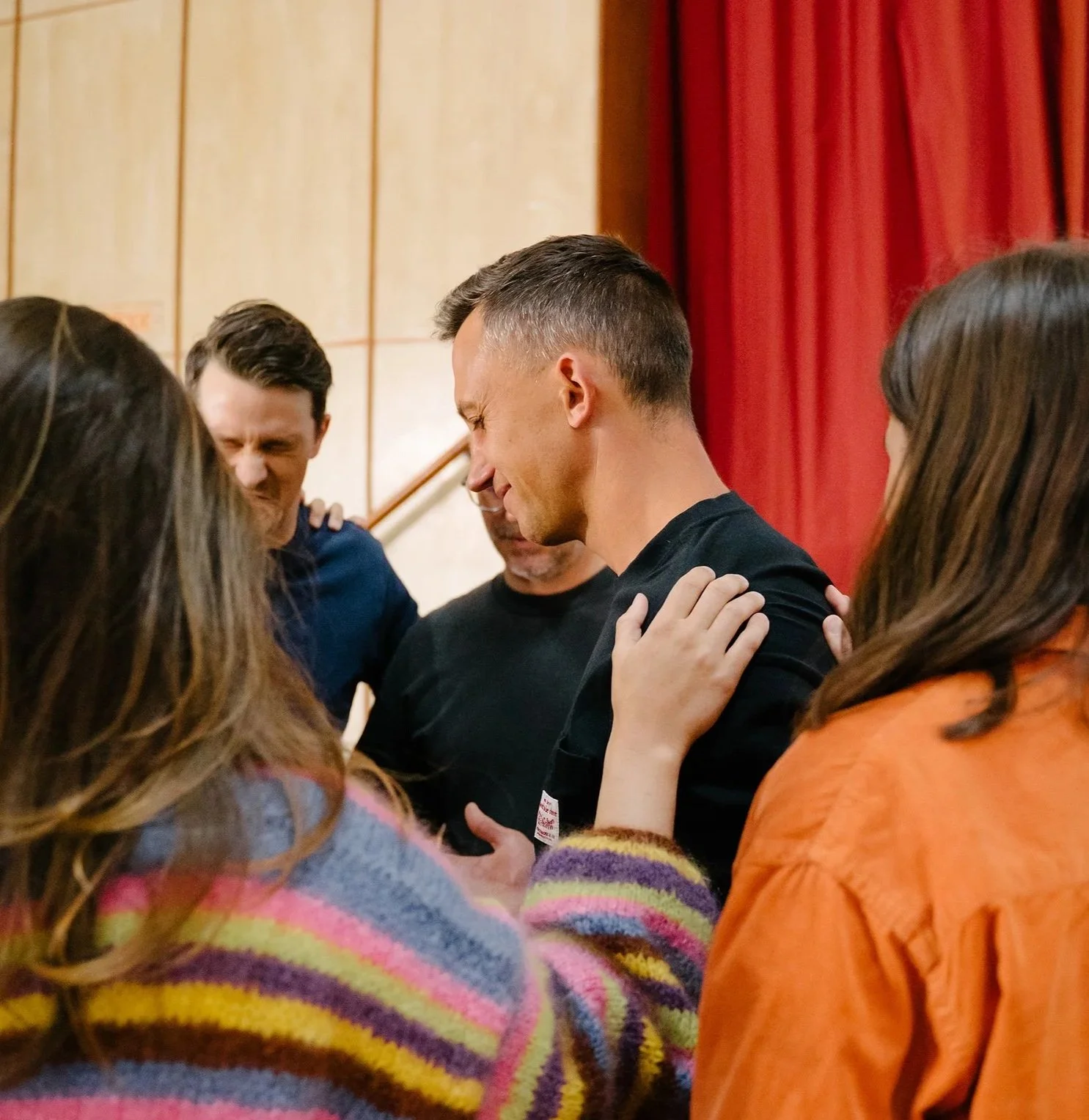 People gathered in a circle praying