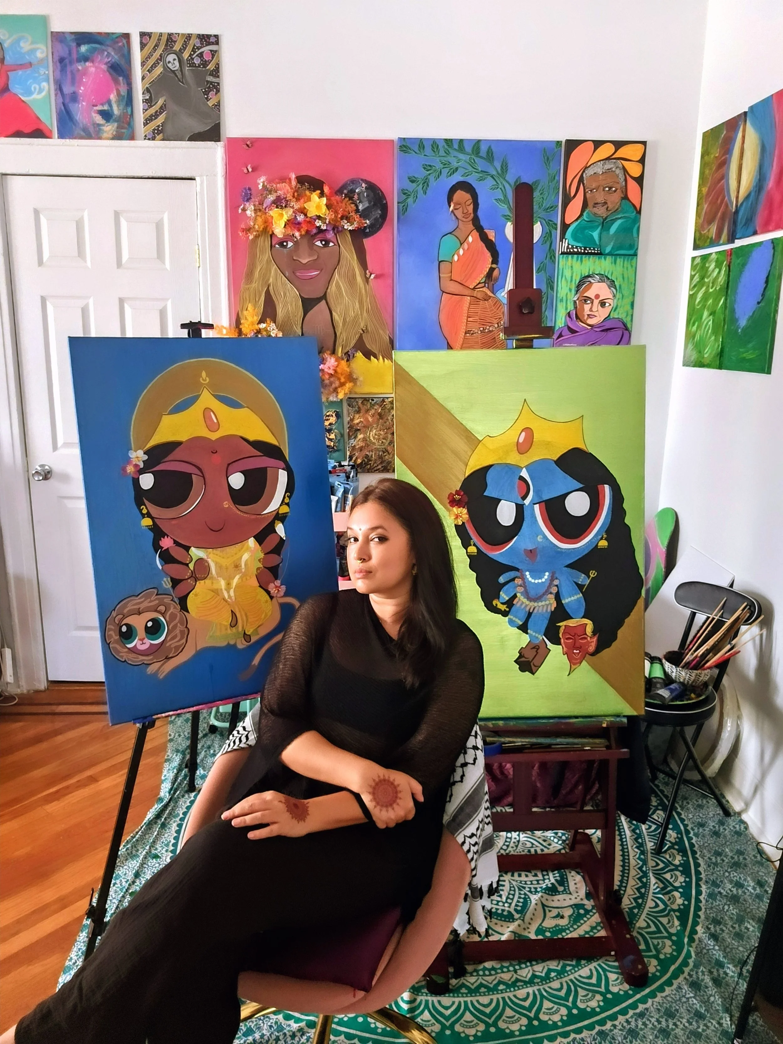 Woman sitting on the floor with her arms crossed, surrounded by colorful artwork of anime-style characters in a room with wooden floor and patterned rug.