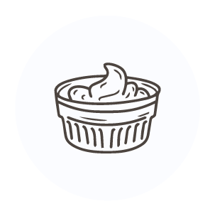 A container of sour cream with a spoon in it