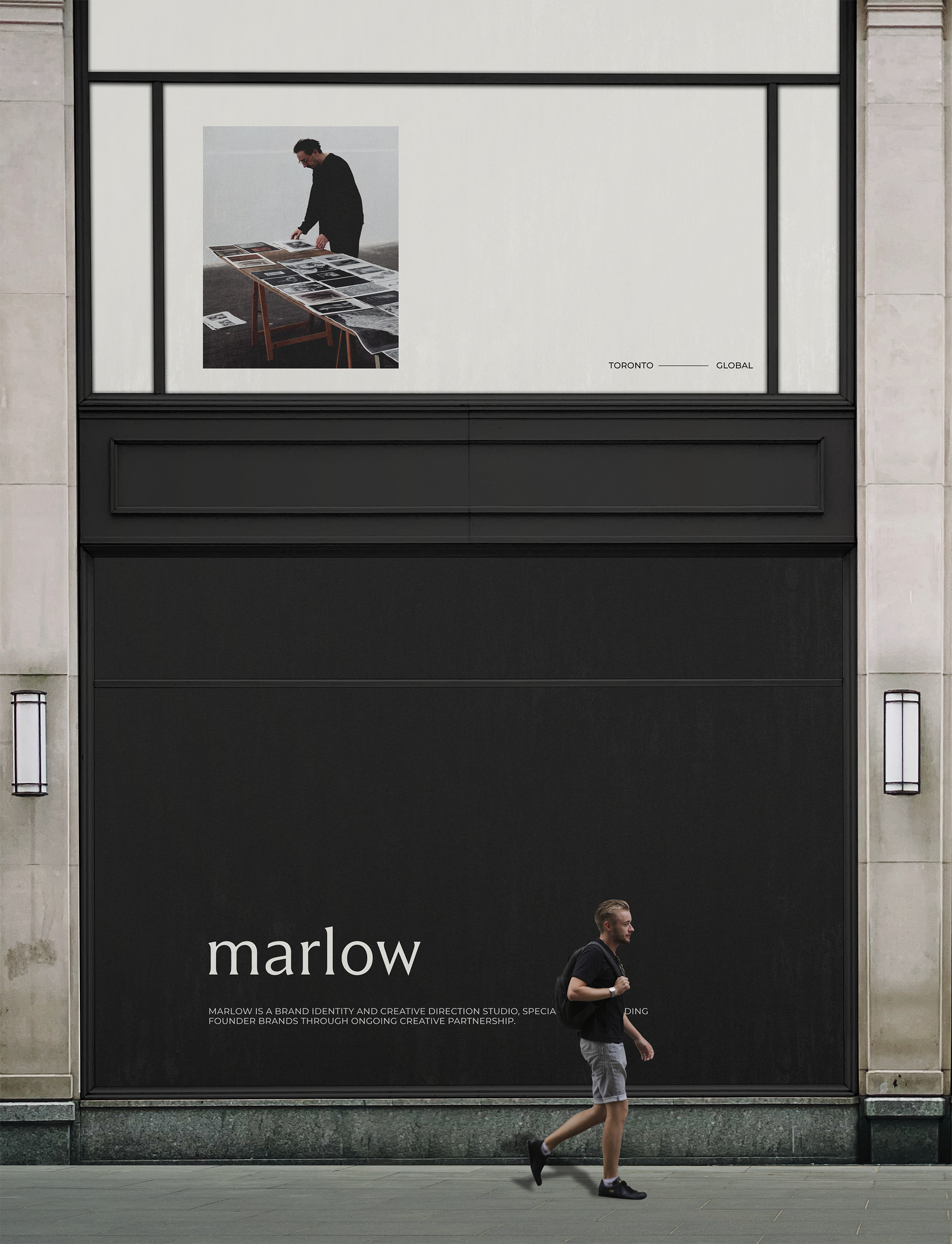 A large window display with a man walking past. The display features a large black banner with the word 'marlow' in white text, and smaller text below describing Marlow as a brand identity and creative studio based in Toronto.