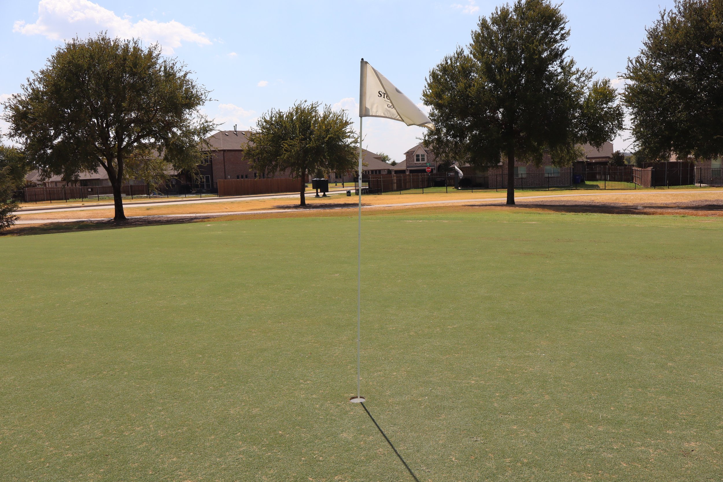 Stone River golf course putting green and flag in Royse City, Texas
