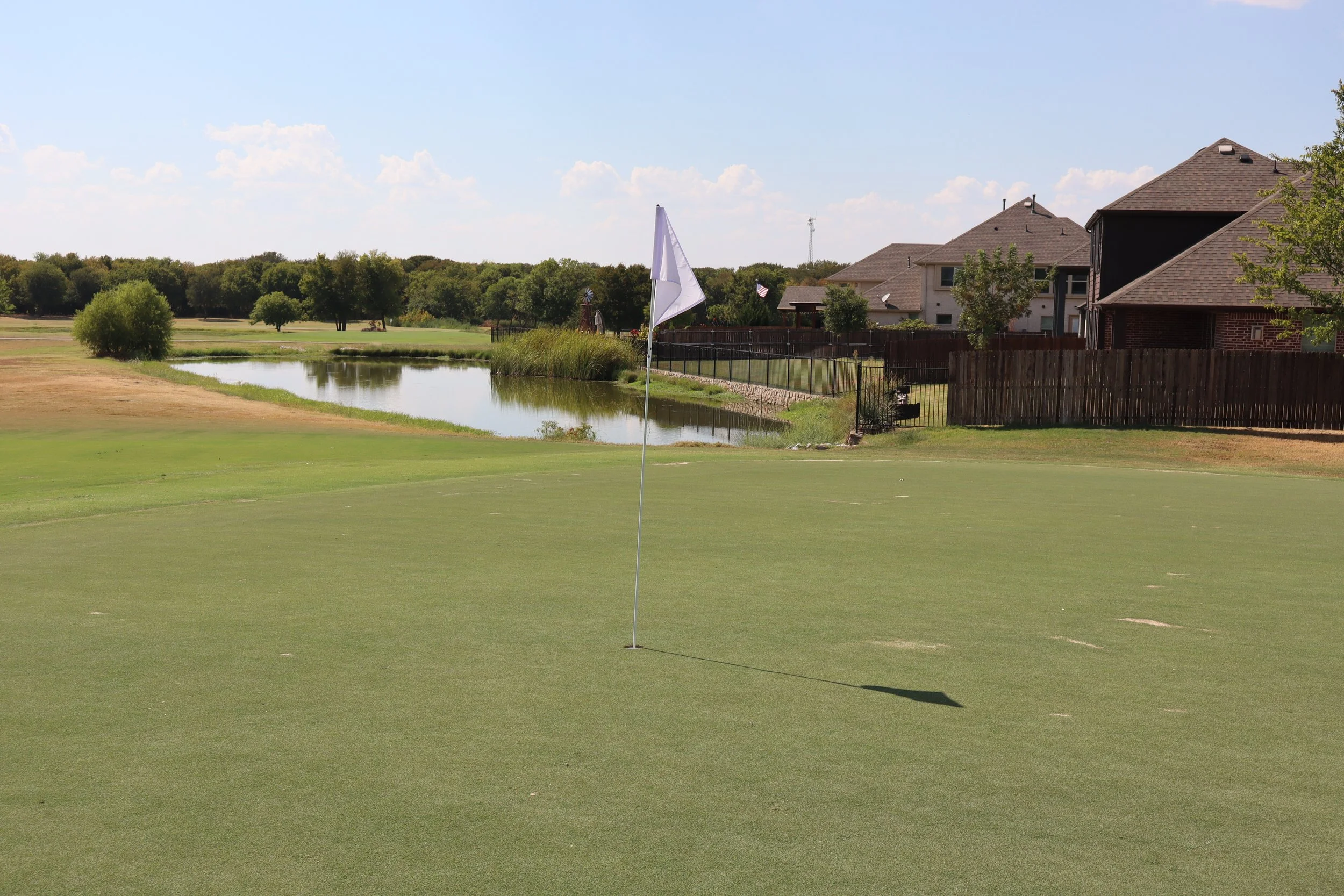 Stone River golf course green and pond beside homes in Royse City, Texas