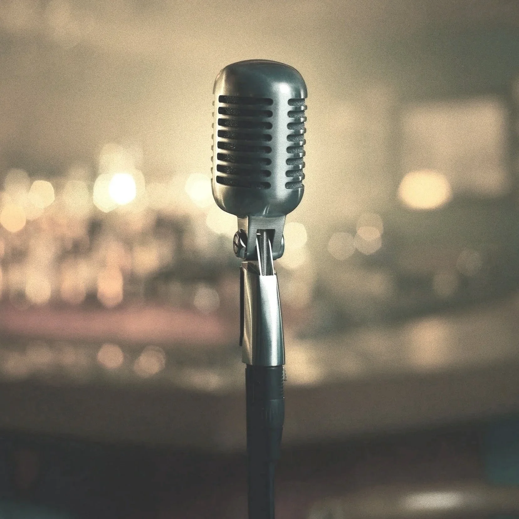 A vintage microphone; cover art for the song "Love Can Be The Funniest Thing", vocals, lyrics and music by Kristen Carelle