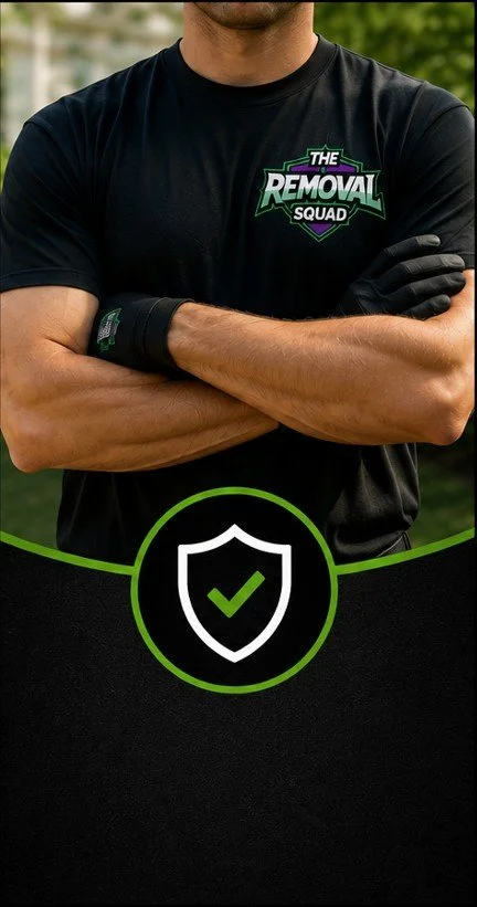 Person wearing a black t-shirt with "The Removal Squad" logo crossing their arms outdoors.