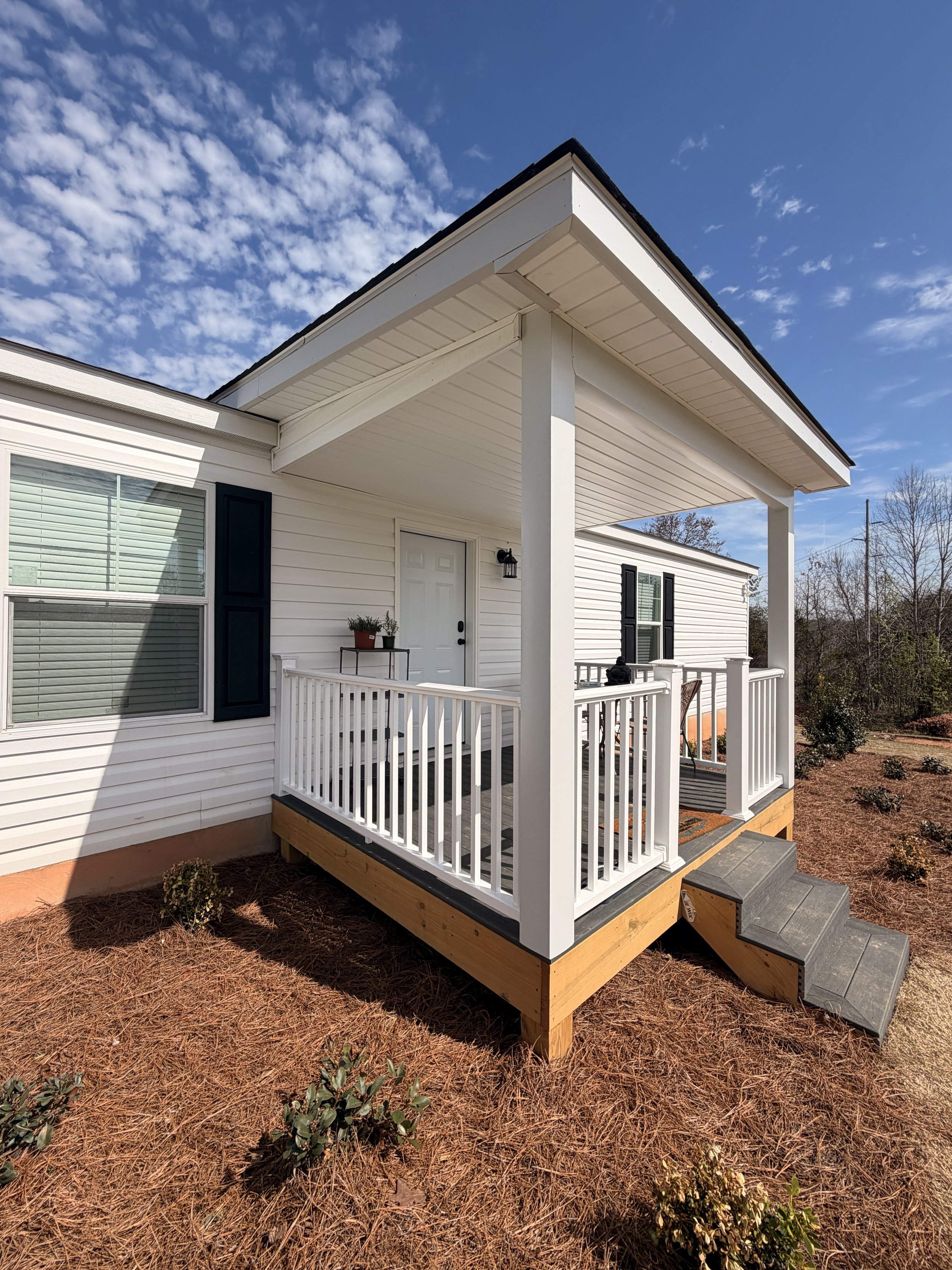Custom covered deck with a roof built by Modern Edge Builders in Marion, NC.