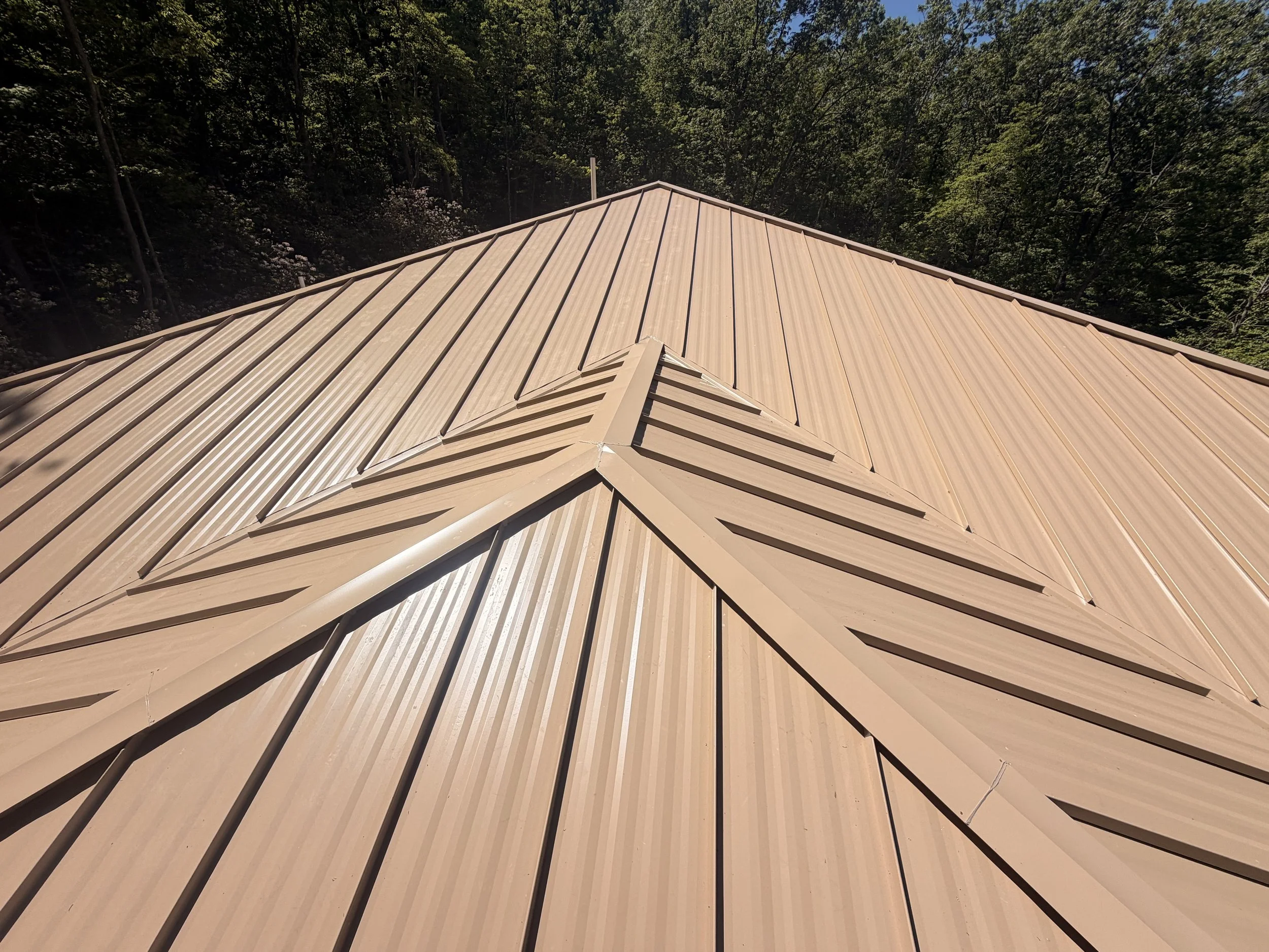 Bronze standing seam metal roof installed on a custom residential home by Modern Edge Builders in Western North Carolina.