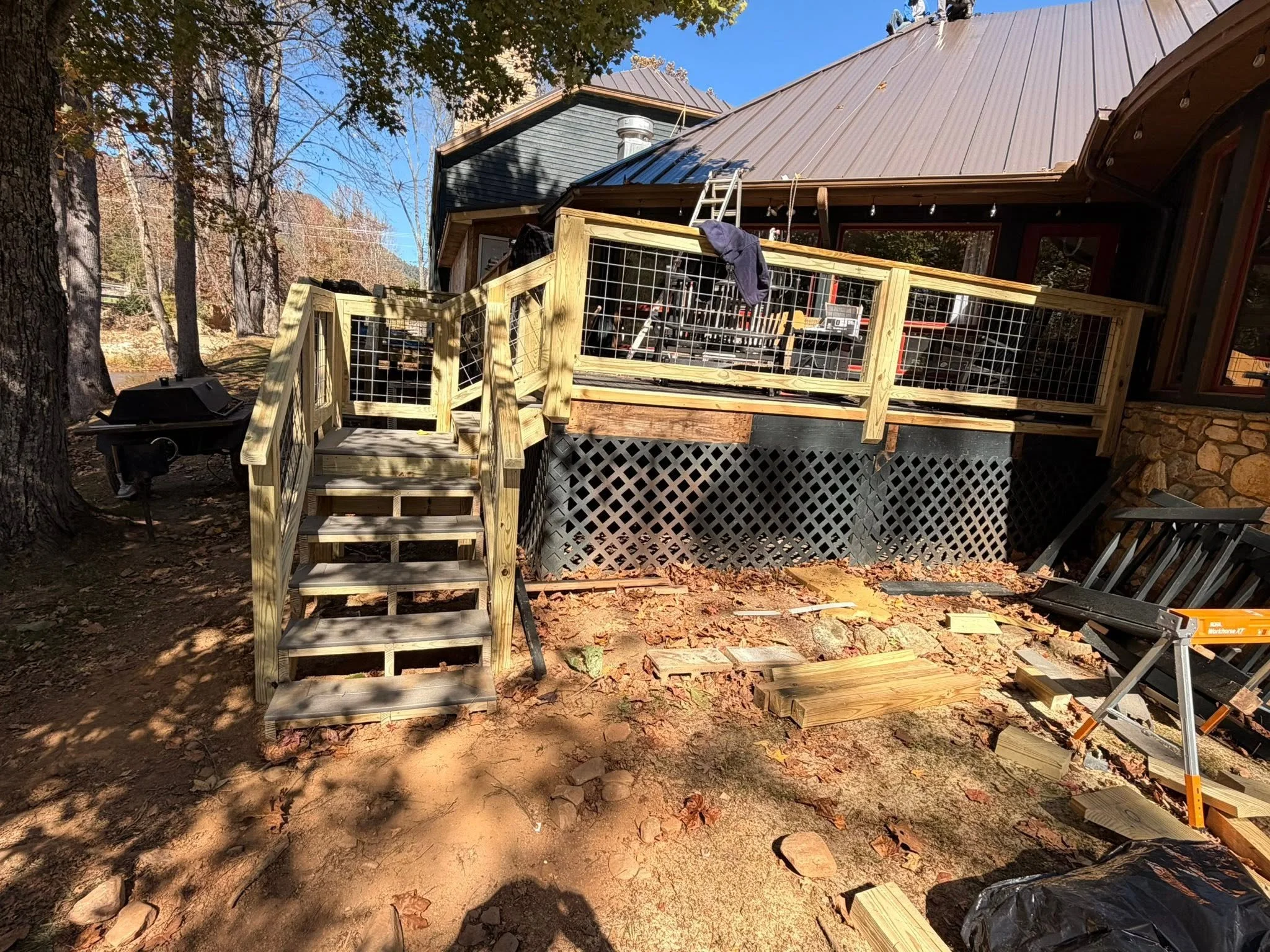 Completed covered deck with modern wire railing built by Modern Edge Builders in Western North Carolina.