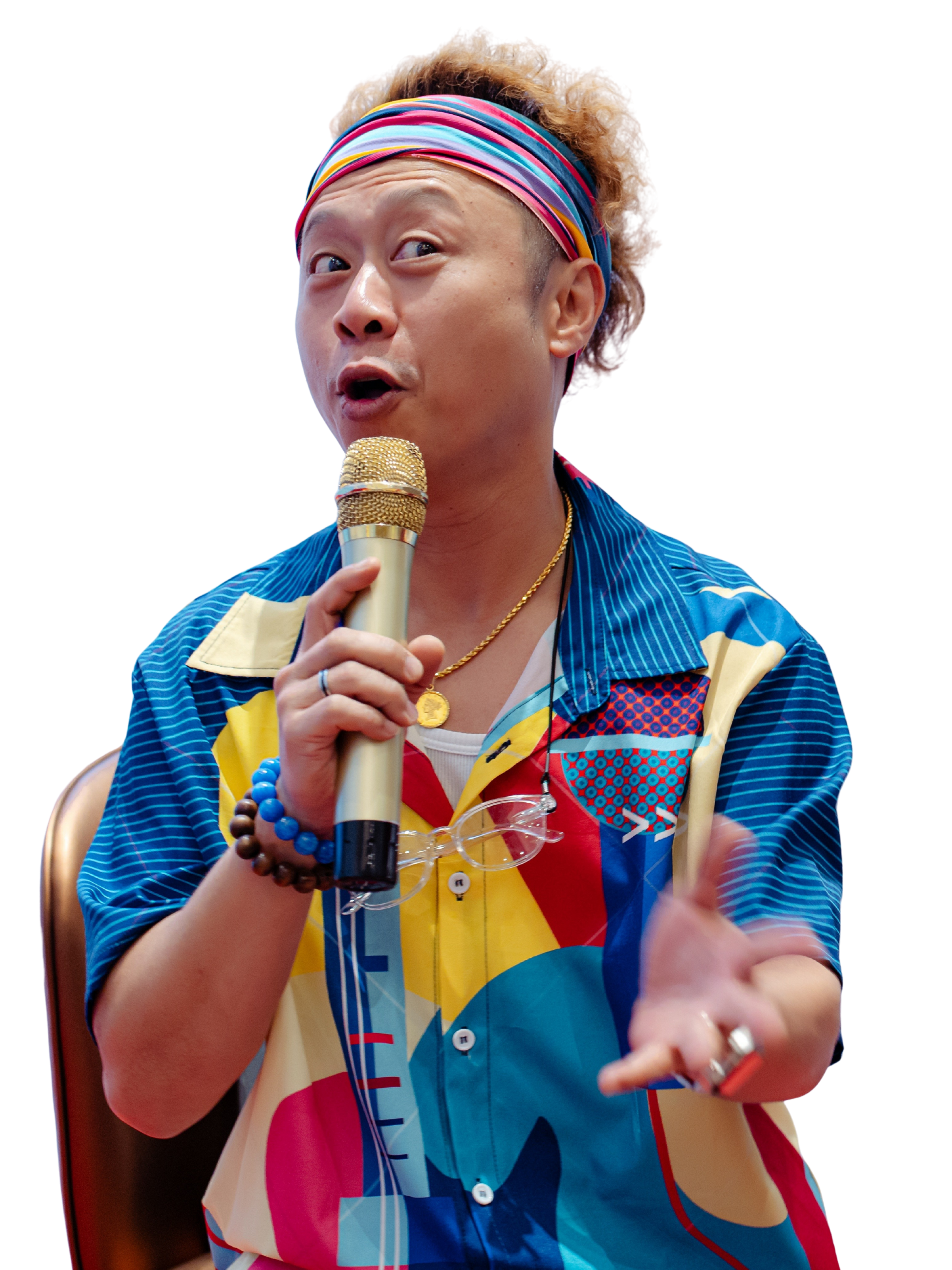 Jason Elpheus Wong, holding a microphone, likely speaking or performing at an event.