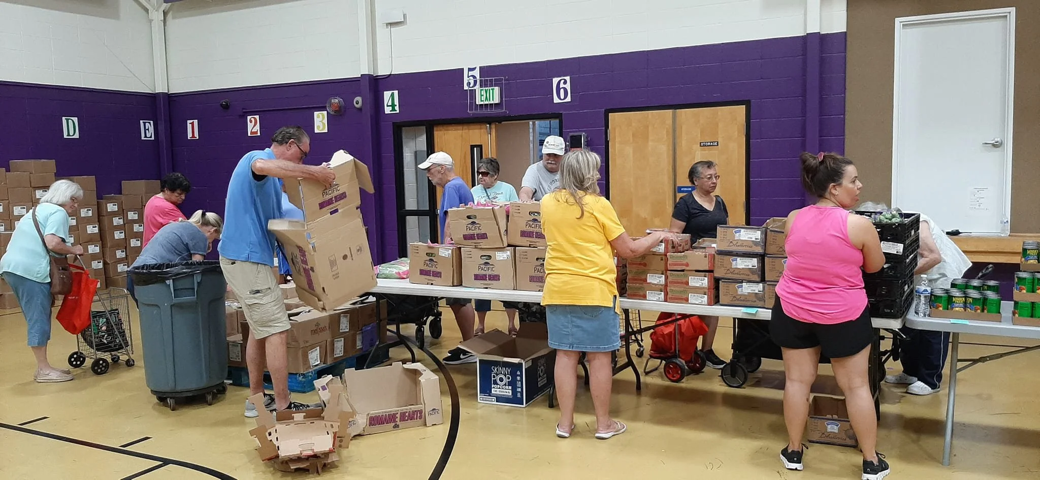 Volunteers from First Christian Church in Marion, Indiana, Grant County help sort and pass out food at Kendall Elementary School for the 2nd Harvest Food Bank.