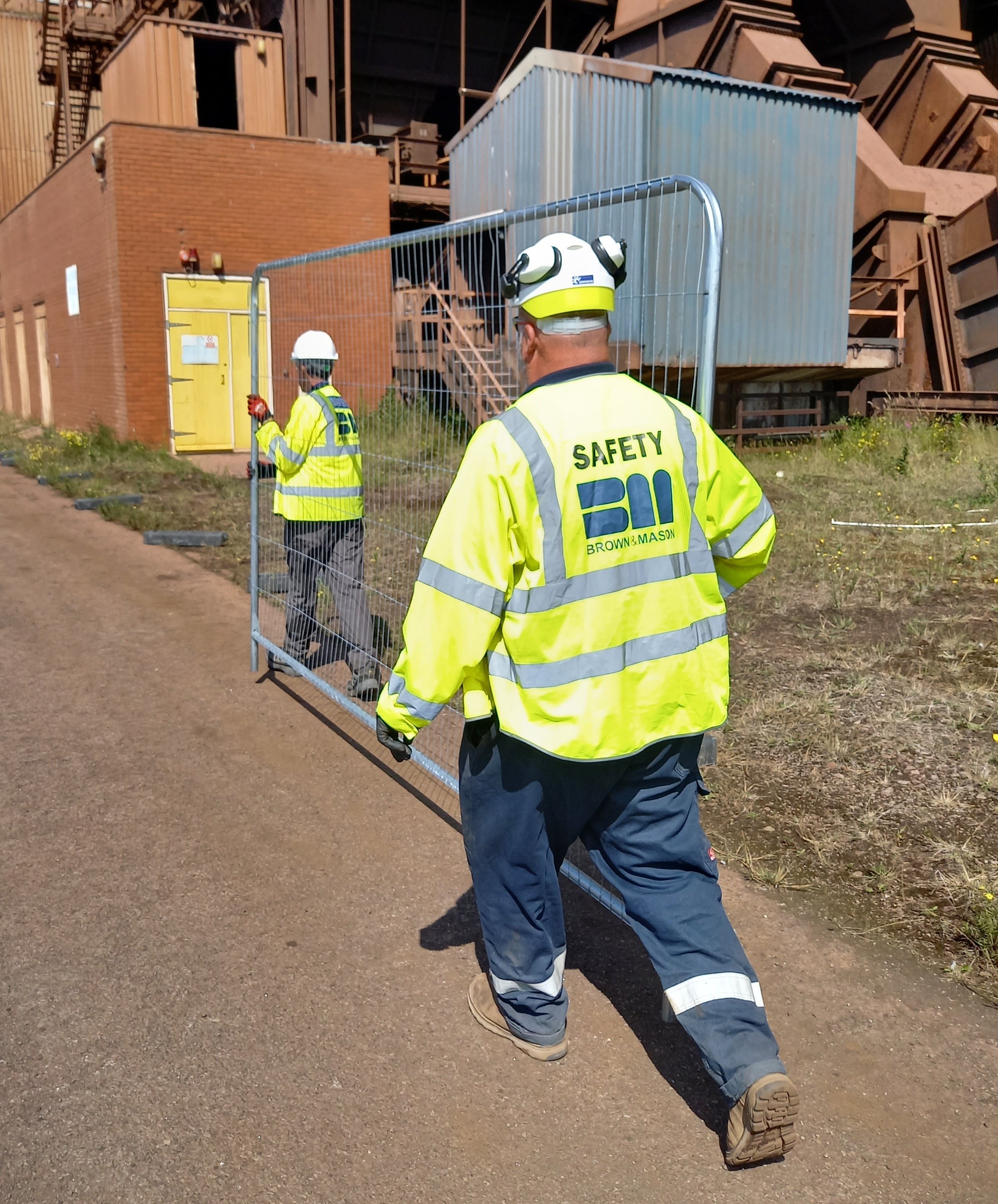 Calum assisting one of his team on site