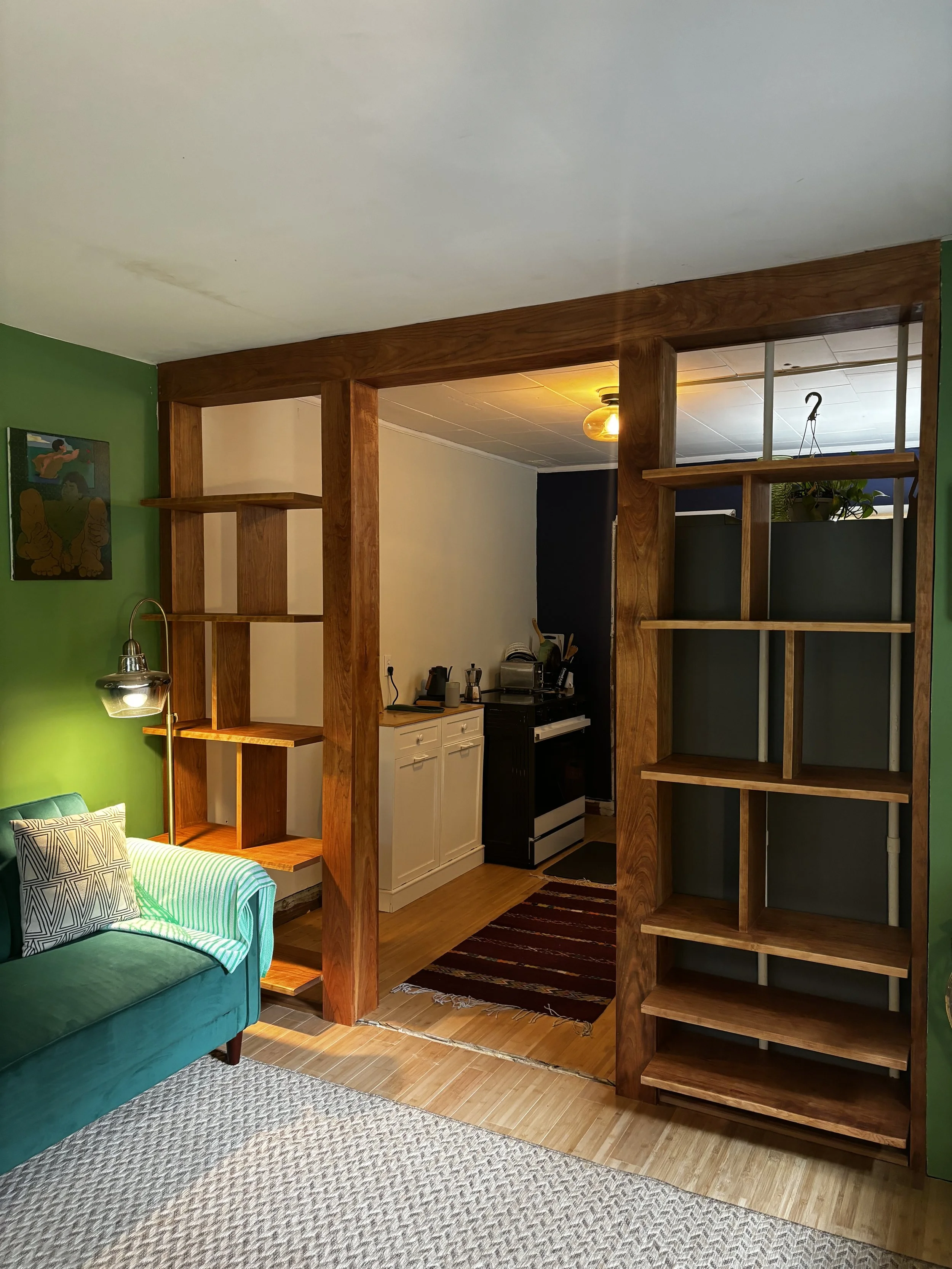 Living room with a simple and modern custom wooden room divider built in.