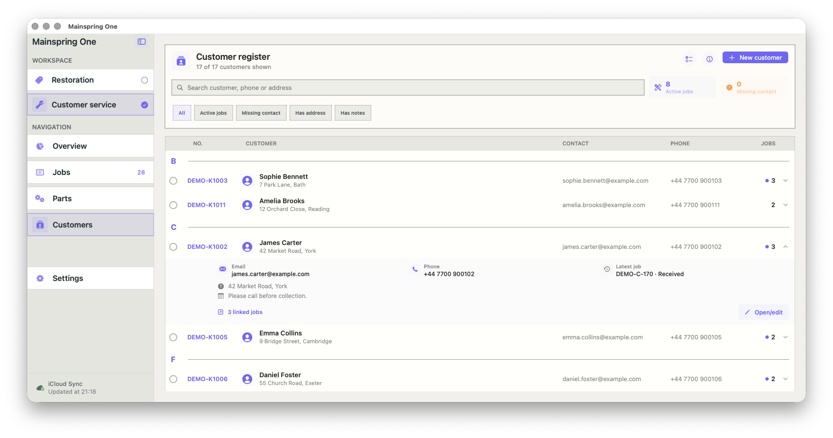 Screenshot of a customer management interface showing a list of customers with contact details, orders, and active jobs in a web app named Mainspring One.